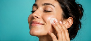 A person applying skincare